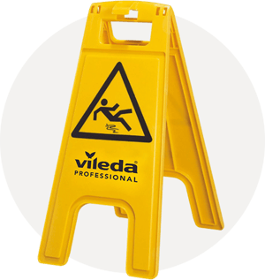 A bright yellow, A-frame plastic floor sign from Vileda Professional. The sign features a black triangular warning symbol depicting a person slipping, positioned above the "vileda PROFESSIONAL" logo. It is shown standing open against a soft, circular grey background.